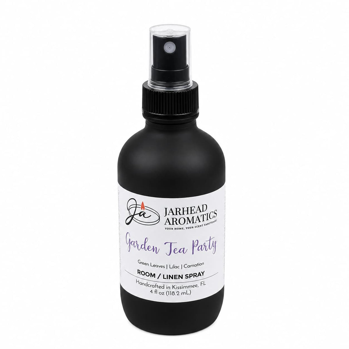 A black spray bottle labeled Jarhead Aromatics Garden Tea Party Room & Linen Spray offers a floral fragrance blend of rose, lilac, and jasmine—evoking the essence of a blooming garden. Handcrafted in Kissimmee, FL, this 4 fl oz home fragrance is perfect for refreshing any room or linen.
