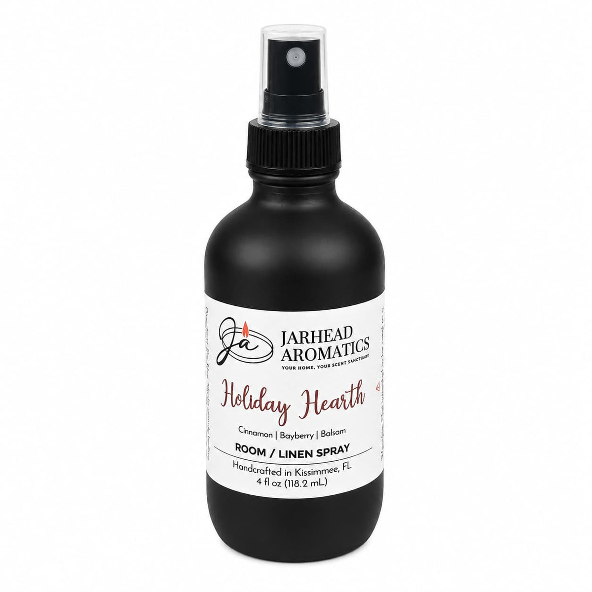 Black spray bottle featuring a white label for the Holiday Hearth Room & Linen Spray | Cinnamon Clove, Bayberry & Balsam, with notes of cinnamon, bayberry, and balsam.