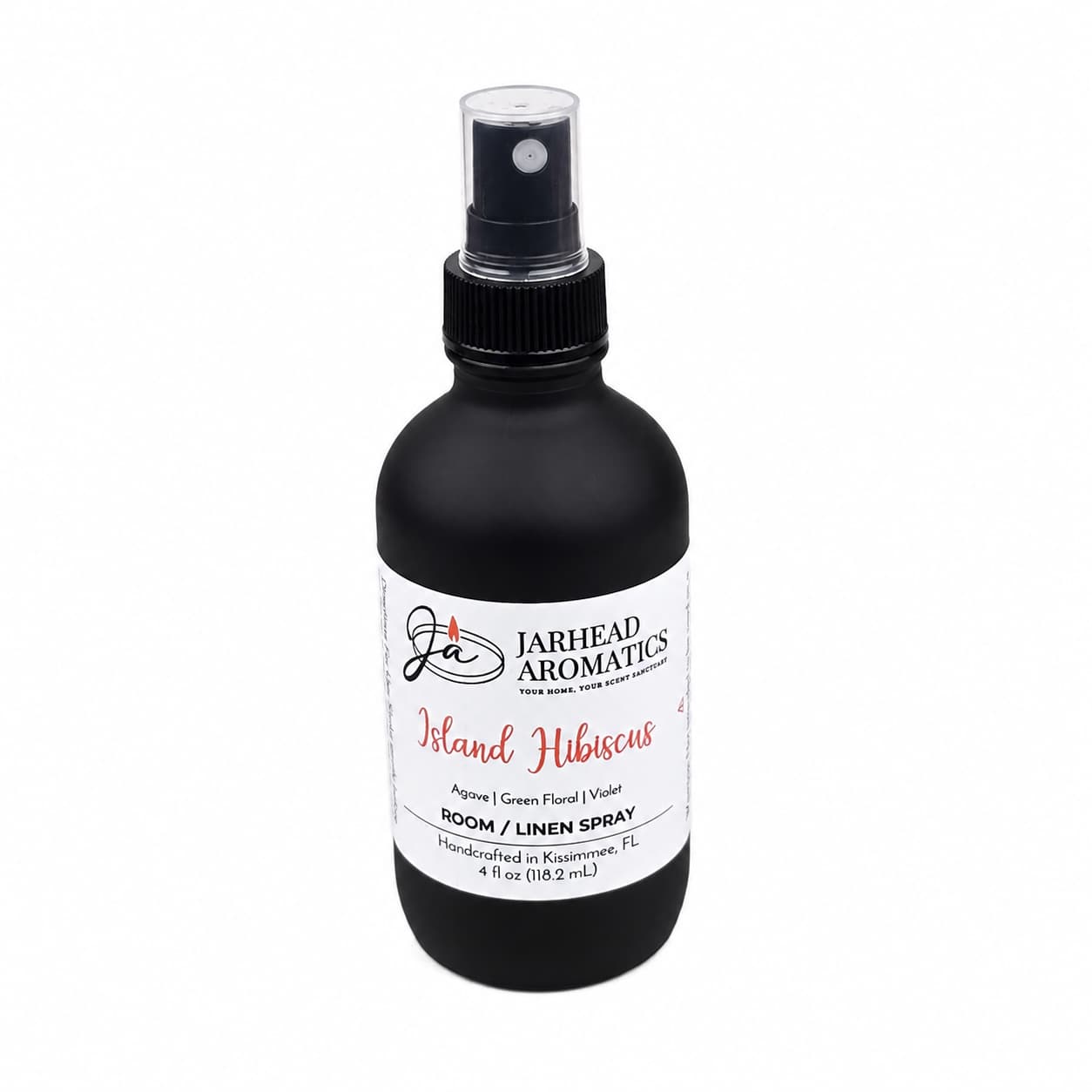 A black spray bottle labeled Jarhead Aromatics Island Hibiscus Room & Linen Spray features a fresh, tropical fragrance with notes of honeydew, lime, and tropical florals. This 4 oz linen spray is handcrafted in Kissimmee, FL, perfect for adding an island-inspired touch to any space.