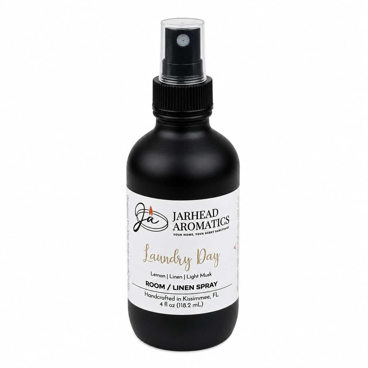 A black spray bottle labeled Jarhead Aromatics Laundry Day Room & Linen Spray features the Fresh Linen, Lemon & Clean Musk scent. Handcrafted in Kissimmee, FL, this 4-ounce (118.2 mL) bottle offers a clean home fragrance experience.
