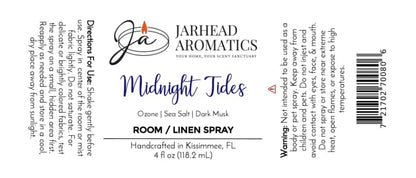 Label for Jarhead Aromatics Midnight Tides Room & Linen Spray | Sea Salt, Sandalwood & Dark Musk, featuring a candle logo at the top. Surround yourself with an invigorating coastal aroma—notes of sea salt, sandalwood, and dark musk evoke the refreshing essence of the ocean air. Directions: Lightly mist onto linens or into any room to revitalize your environment. Warning: Avoid direct contact with eyes and keep out of reach of children.