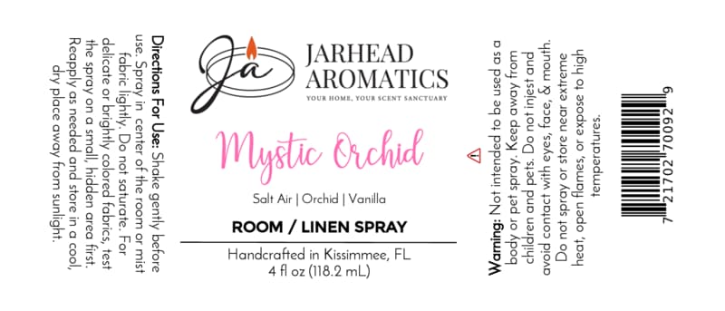 The Mystic Orchid Room & Linen Spray by Jarhead Aromatics features a label with directions, an ingredient list (orchid, salt air, and vanilla), warning information, a barcode, and a note stating it’s handcrafted in Kissimmee, FL. Designed with black and pink text on a white background, this label beautifully conveys the coastal floral essence of your favorite home fragrance.