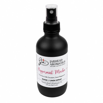 Black spray bottle with a white label reading Peppermint Mocha Room & Linen Spray | Chocolate Mint & Vanilla, listing scent notes of fresh mint, milk chocolate, and sweet peppermint for this holiday room fragrance.