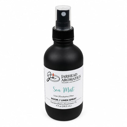 A black spray bottle labeled Jarhead Aromatics Sea Mist Room & Linen Spray features refreshing scent notes of fresh linen, sea salt, and eucalyptus. Handcrafted in Kissimmee, FL, this spa-inspired coastal home fragrance is available in a 4 fl oz size.