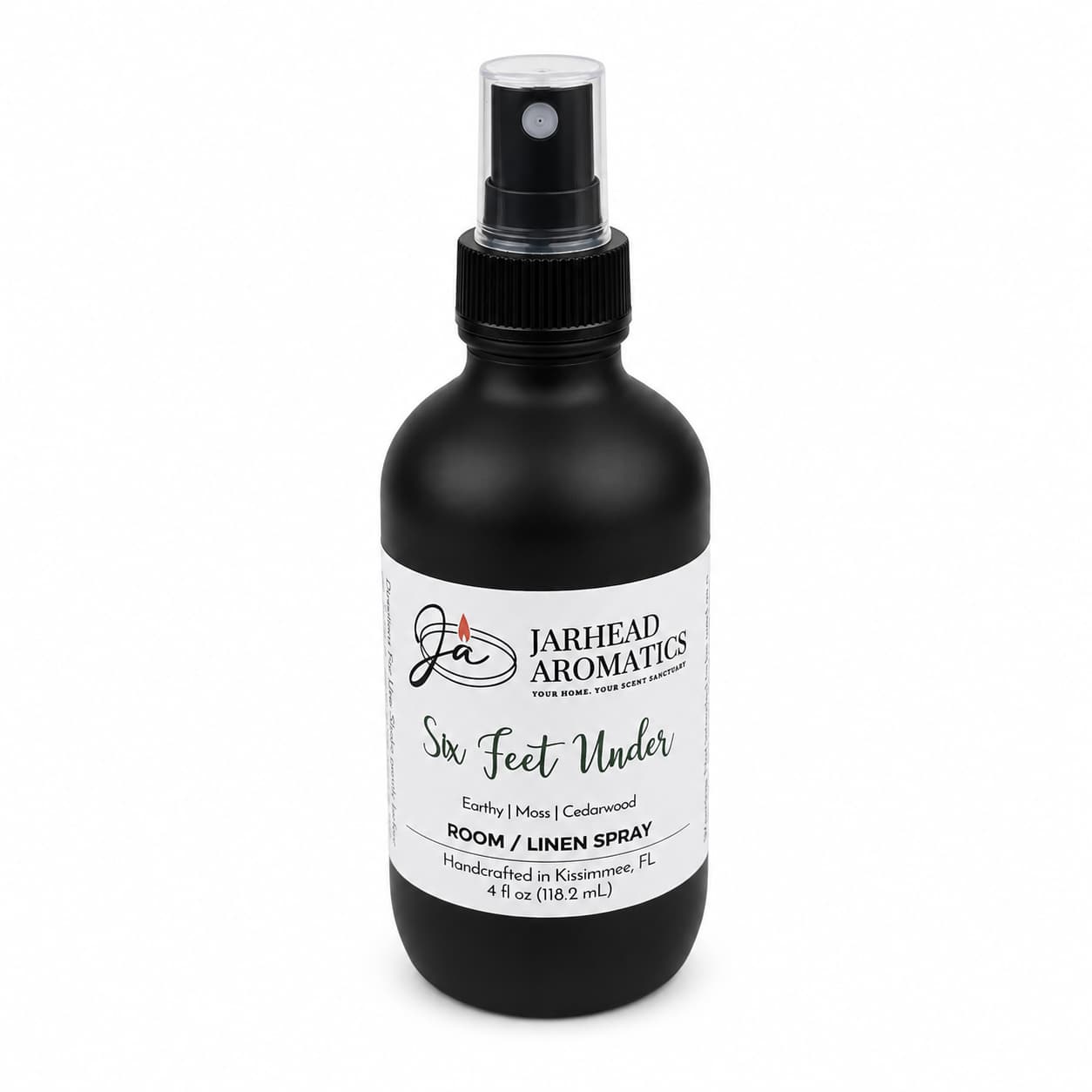 A handcrafted 4 oz black spray bottle labeled Jarhead Aromatics Six Feet Under Room & Linen Spray | Damp Earth, Moss & Ancient Oak offers an earthy home fragrance with notes of moss and ancient oak. Made in Kissimmee, FL, it’s a perfect addition to your home fragrance collection.