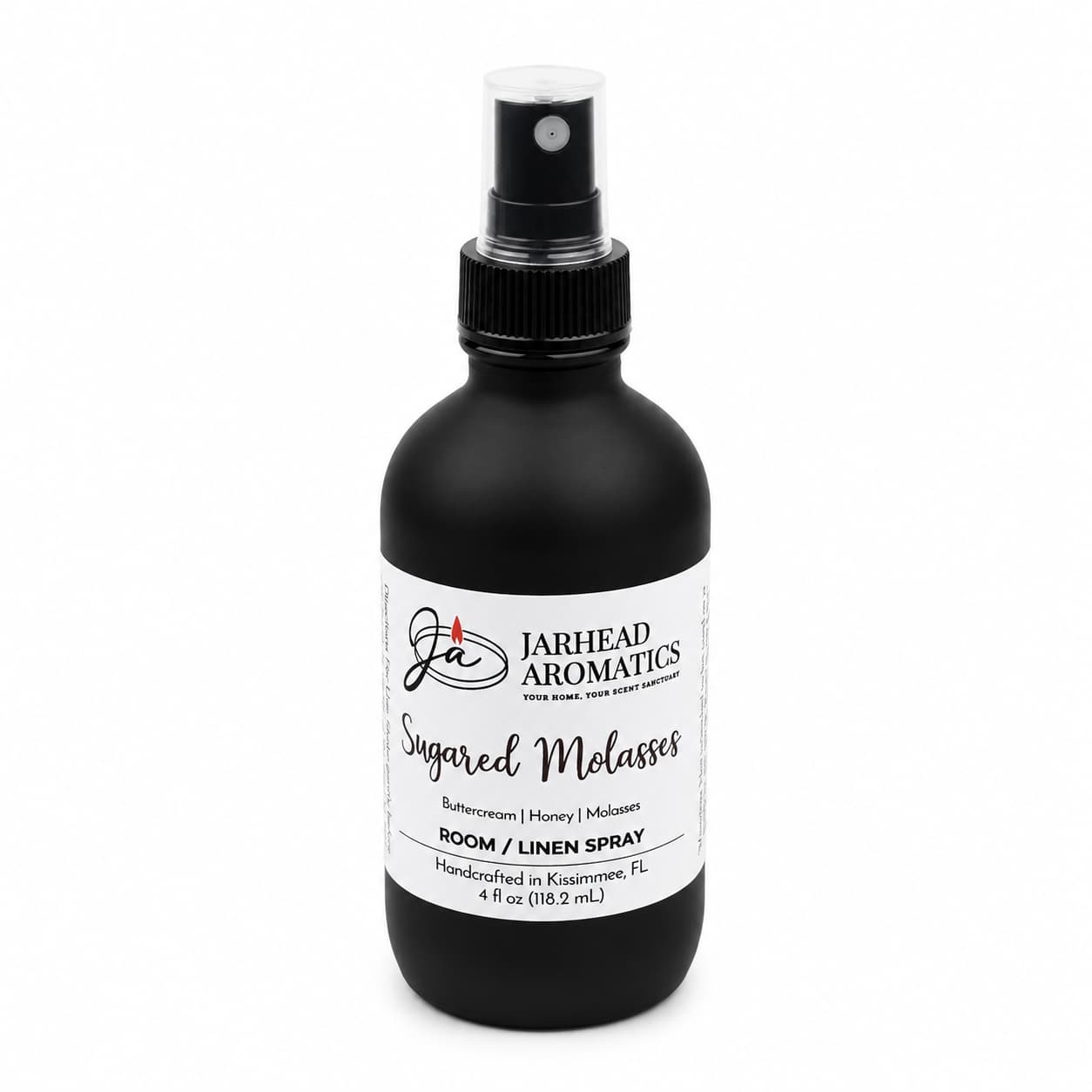 A black spray bottle of Jarhead Aromatics Sugared Molasses Room & Linen Spray, featuring notes of buttercream, honey, and dark molasses. This gourmand home fragrance doubles as both a linen spray and room refresher, comes in a 4 fl oz (118.2 mL) size, and is handcrafted in Kissimmee, FL.