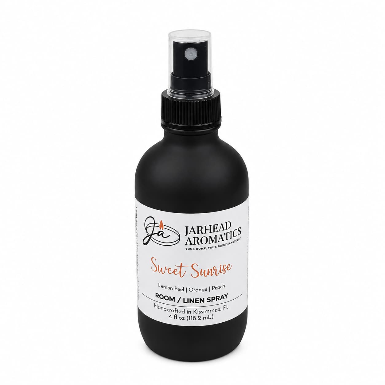 A black spray bottle labeled “Jarhead Aromatics Sweet Sunrise Room & Linen Spray | Lemon, Orange, Peach & Citrus” offers a delightful blend of citrus and fruity scents for your home. This room spray is displayed on a white background.