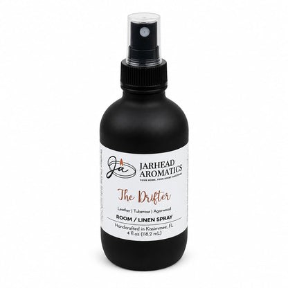 A black bottle of Jarhead Aromatics The Drifter Room & Linen Spray, featuring a spray nozzle and notes of leather, tuberose, and smoky agarwood—a western-inspired fragrance handcrafted in Kissimmee, FL.