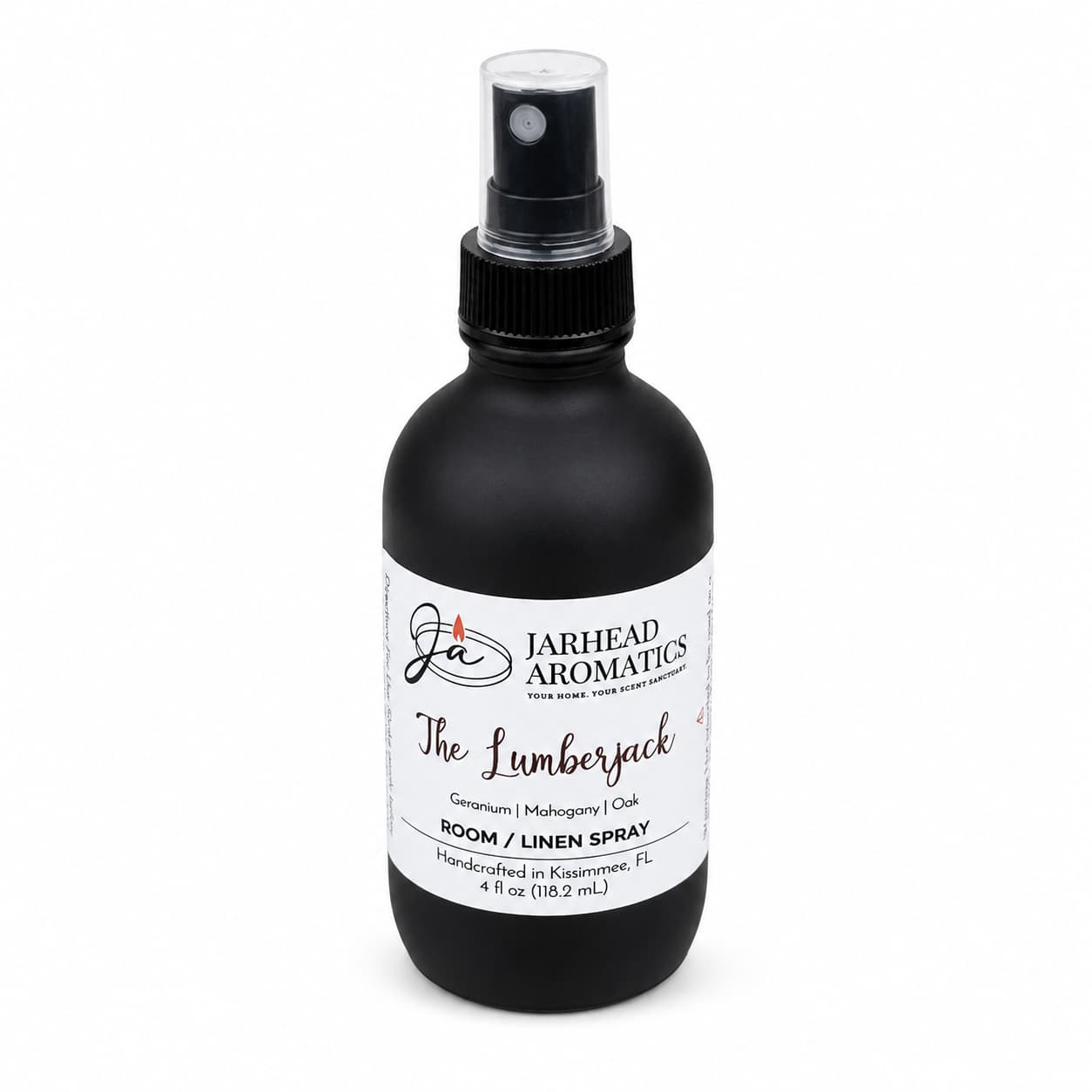 A black spray bottle labeled Jarhead Aromatics The Lumberjack Room & Linen Spray, featuring notes of mahogany, cedarwood, and oak, is handcrafted in Kissimmee, FL. This woodsy home fragrance comes with a black cap and is displayed against a clean white background.