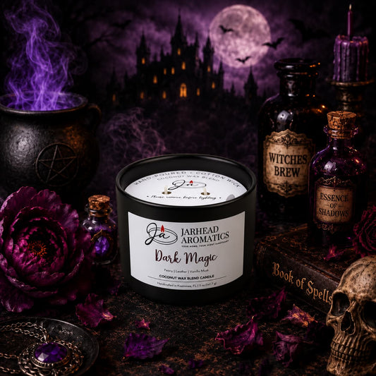 A Dark Magic Coconut Wax Blend Candle in a black jar surrounded by a purple peony, a skull, apothecary bottles, and a bubbling cauldron against a background of a spooky castle under a full moon.