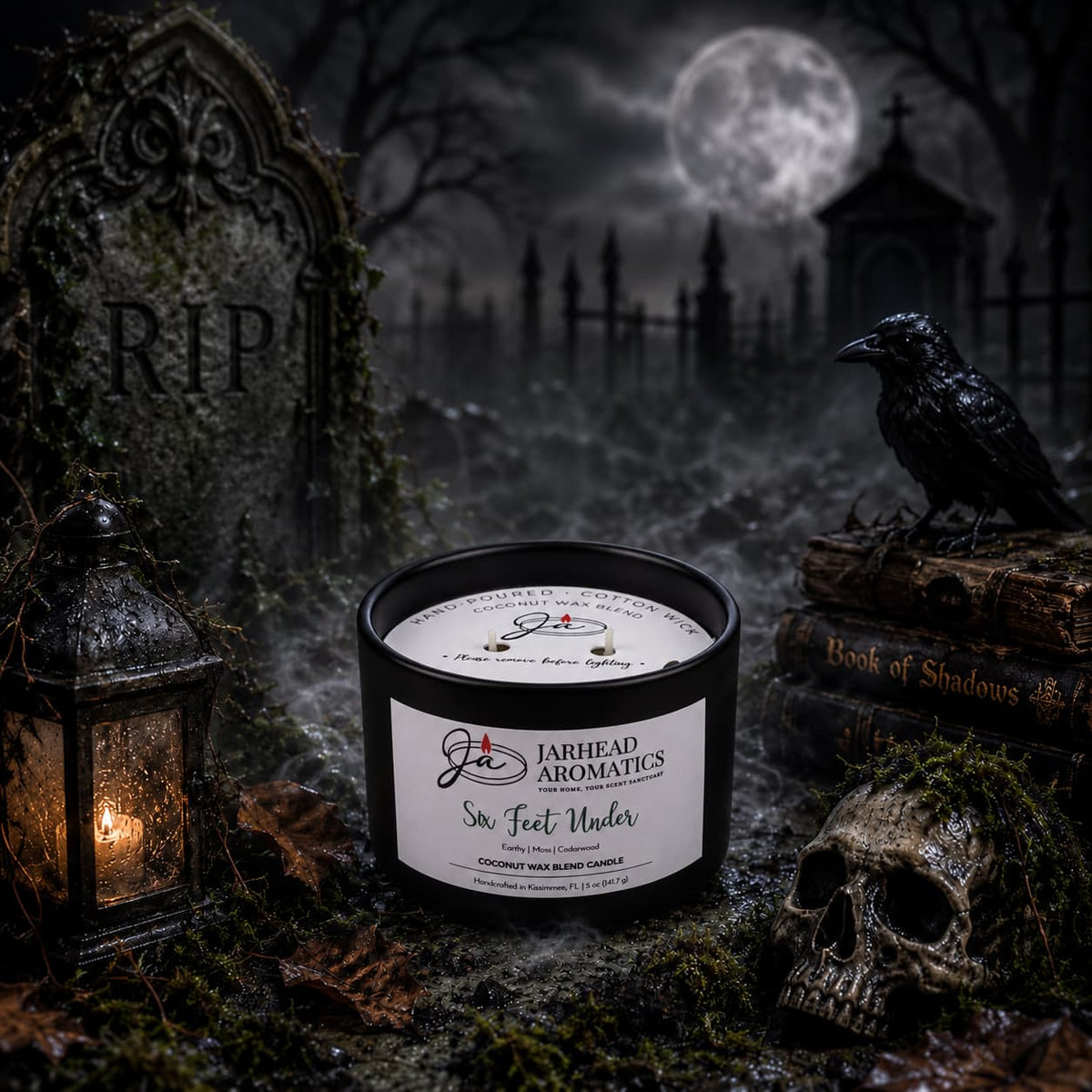 A Six Feet Under Coconut Wax Blend Candle by Jarhead Aromatics sits in a graveyard setting alongside a tombstone, a raven, and a skull.