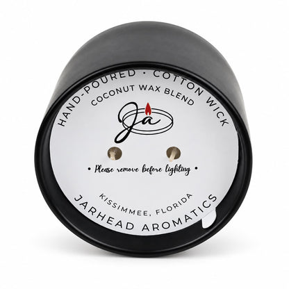 A black, two-wick Coconut Wax Blend Candle, featuring a round label with hand-poured coconut wax blend details and instructions to remove the label before lighting.