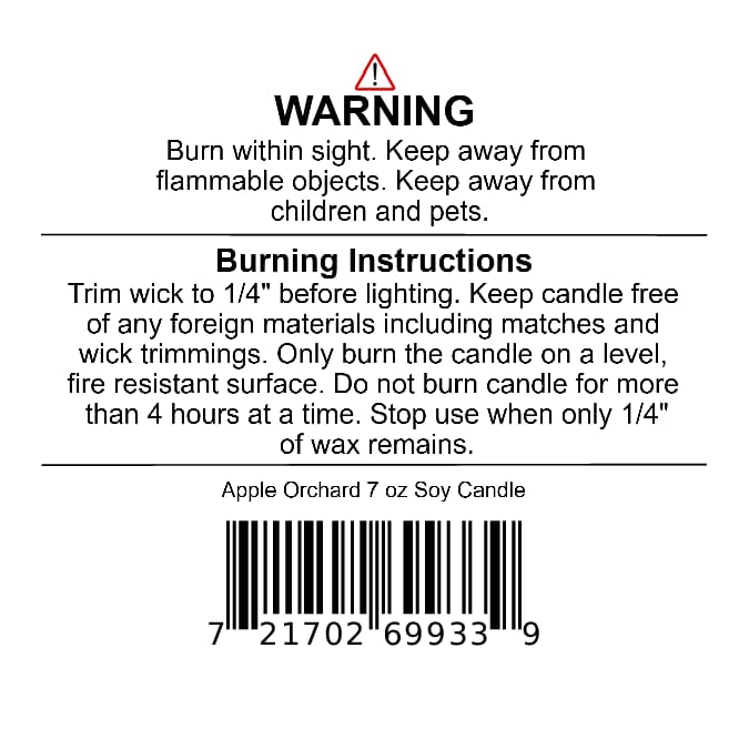 A warning label on a Jarhead Aromatics Apple Orchard Soy Wax Candle | Pear, Apple & Cedar, including burning instructions, safety precautions, product weight, and a barcode.