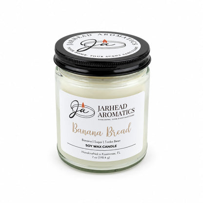 A Banana Bread Soy Wax Candle | Banana, Sugar & Tonka Bean in a glass jar with a black lid.
