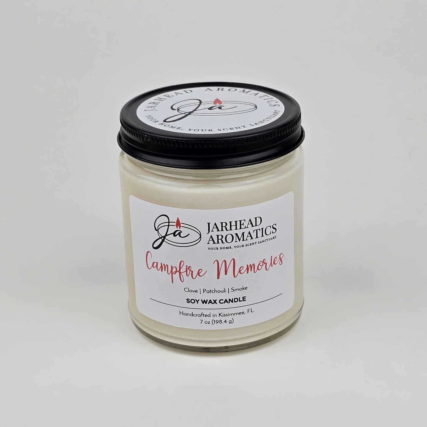 Experience the cozy fragrance of fall with the Jarhead Aromatics Campfire Memories Soy Wax Candle, featuring smoky embers, maple, moss, and patchouli. Handcrafted in Kismet, FL, this candle is hand-poured in a clear glass jar with a black lid—perfect for creating warm autumn memories.