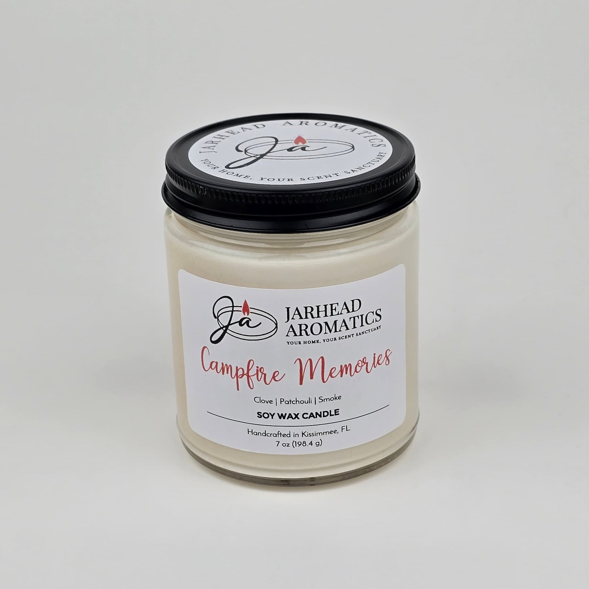 Experience the cozy fragrance of fall with the Jarhead Aromatics Campfire Memories Soy Wax Candle, featuring smoky embers, maple, moss, and patchouli. Handcrafted in Kismet, FL, this candle is hand-poured in a clear glass jar with a black lid—perfect for creating warm autumn memories.