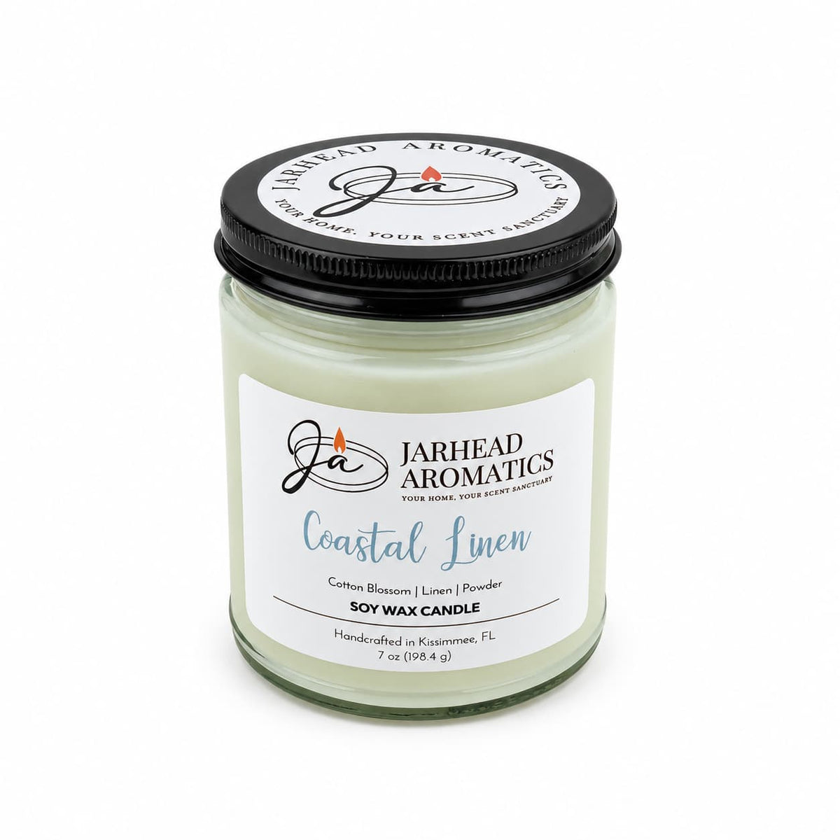 A Jarhead Aromatics Coastal Linen Soy Wax Candle in a glass jar with a black lid and a label reading Cotton Blossom, Linen & Powder.