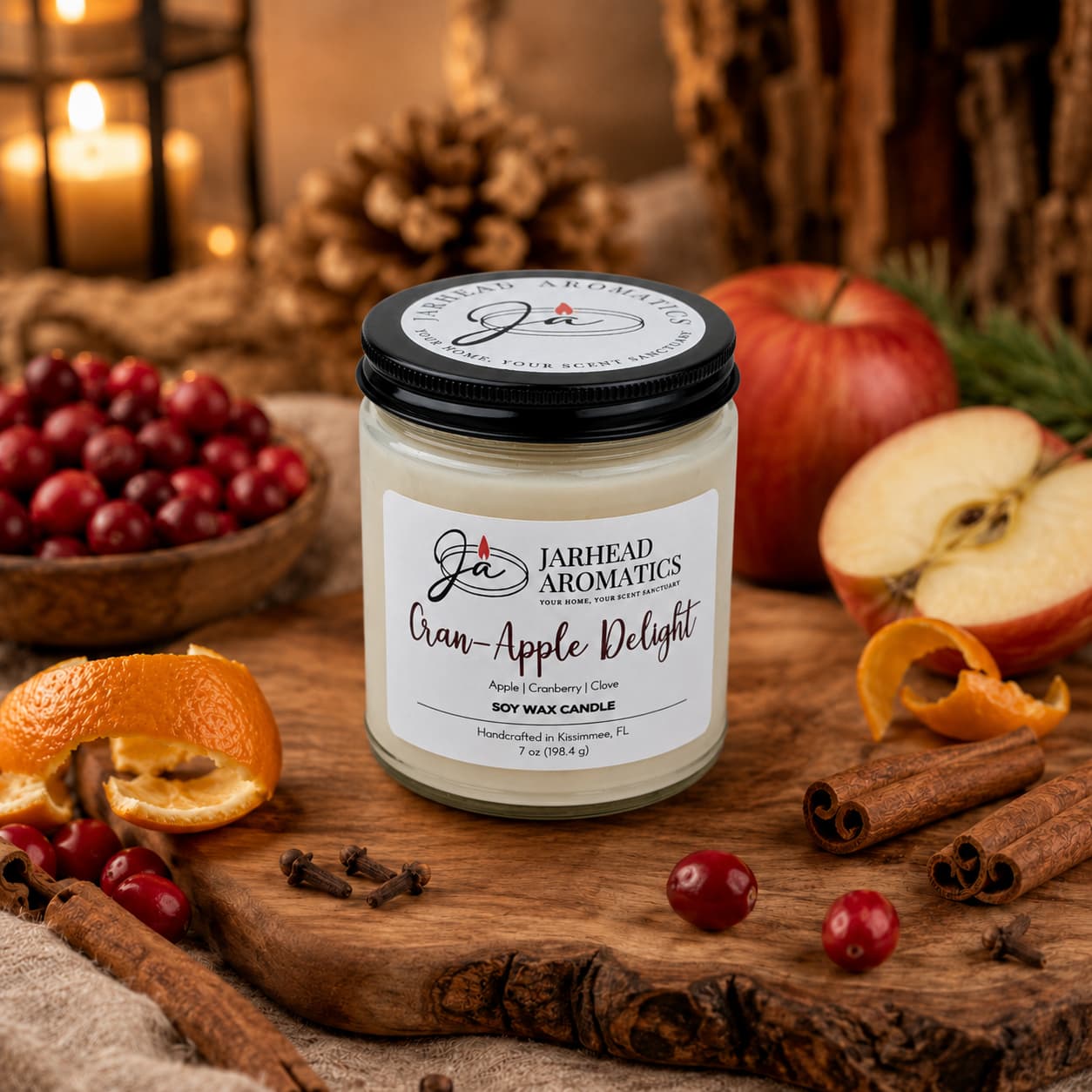 A Jarhead Aromatics Cran-Apple Delight Soy Wax Candle sits on a table surrounded by apples, cranberries, cinnamon sticks, orange peels, and holiday decor in warm lighting, filling the room with its inviting cranberry, apple, and cinnamon scent.