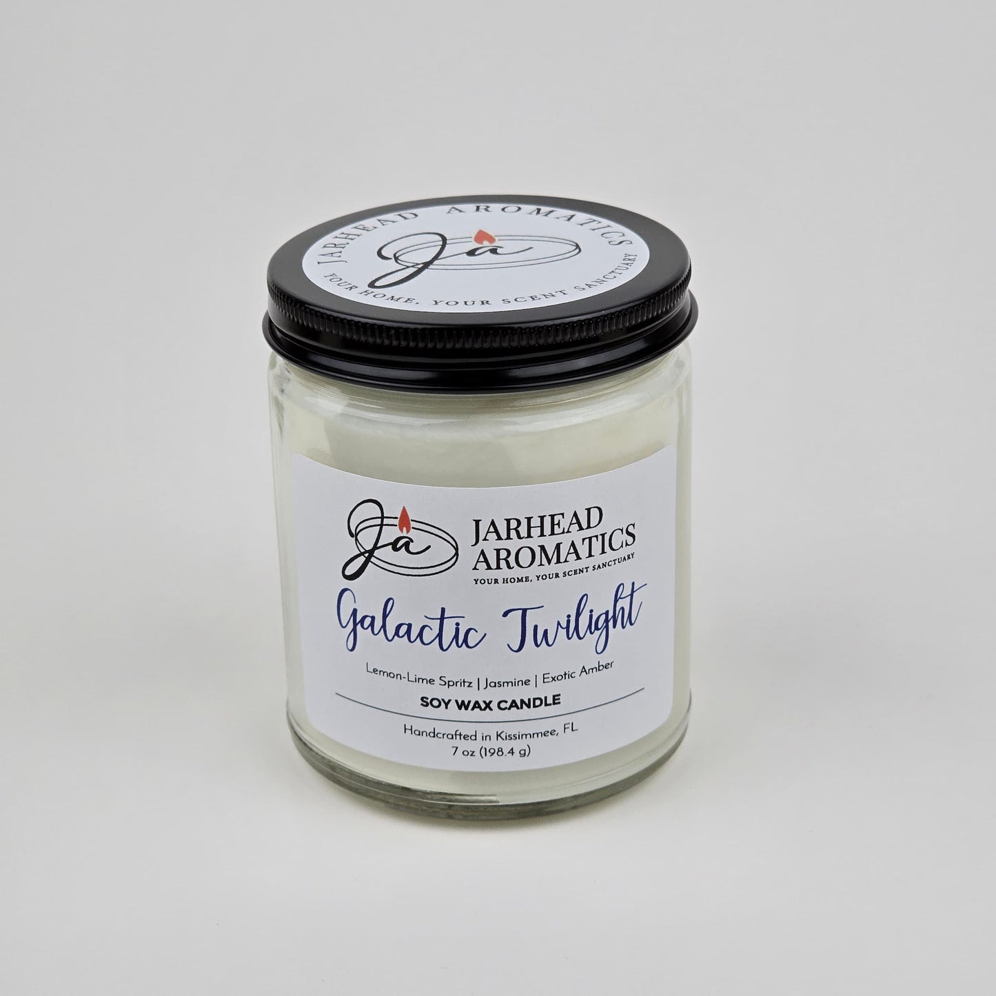 The Jarhead Aromatics Galactic Twilight Soy Wax Candle features a bergamot, jasmine & amber scent blend. It comes in a glass jar with a black lid and is handcrafted in Kissimmee, FL using premium soy wax.