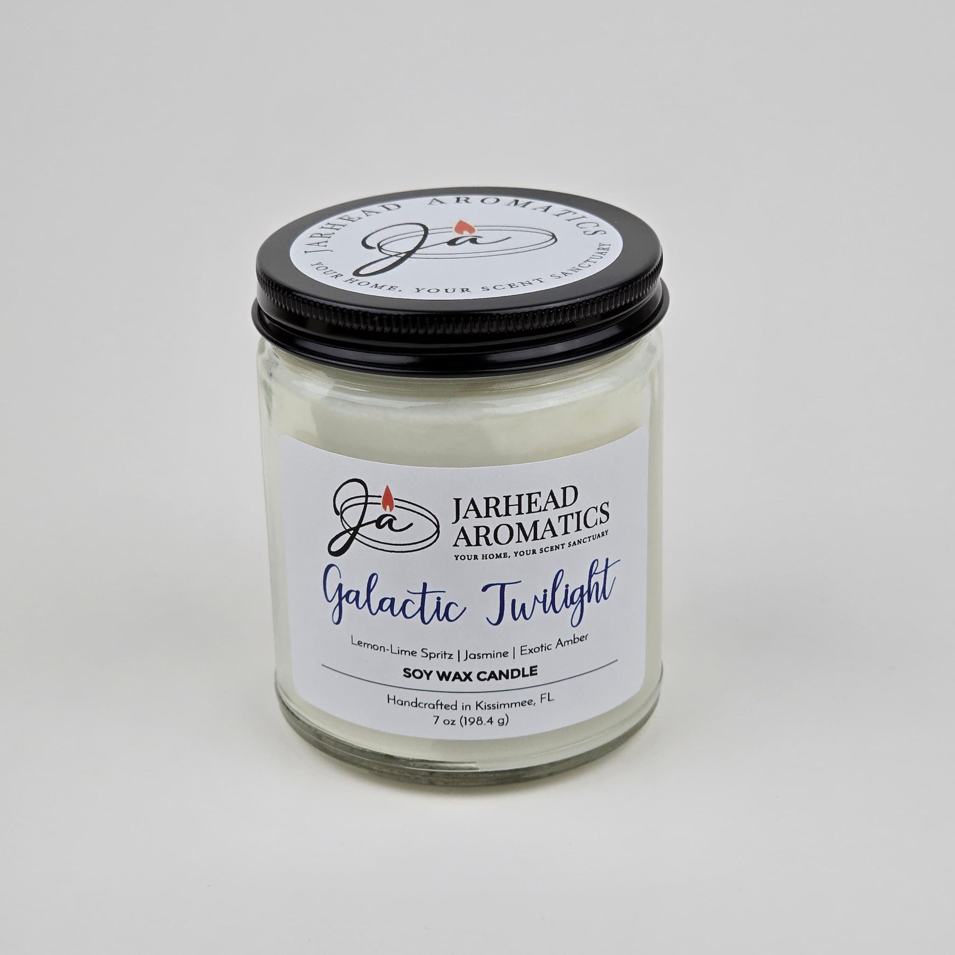 The Jarhead Aromatics Galactic Twilight Soy Wax Candle features a bergamot, jasmine & amber scent blend. It comes in a glass jar with a black lid and is handcrafted in Kissimmee, FL using premium soy wax.