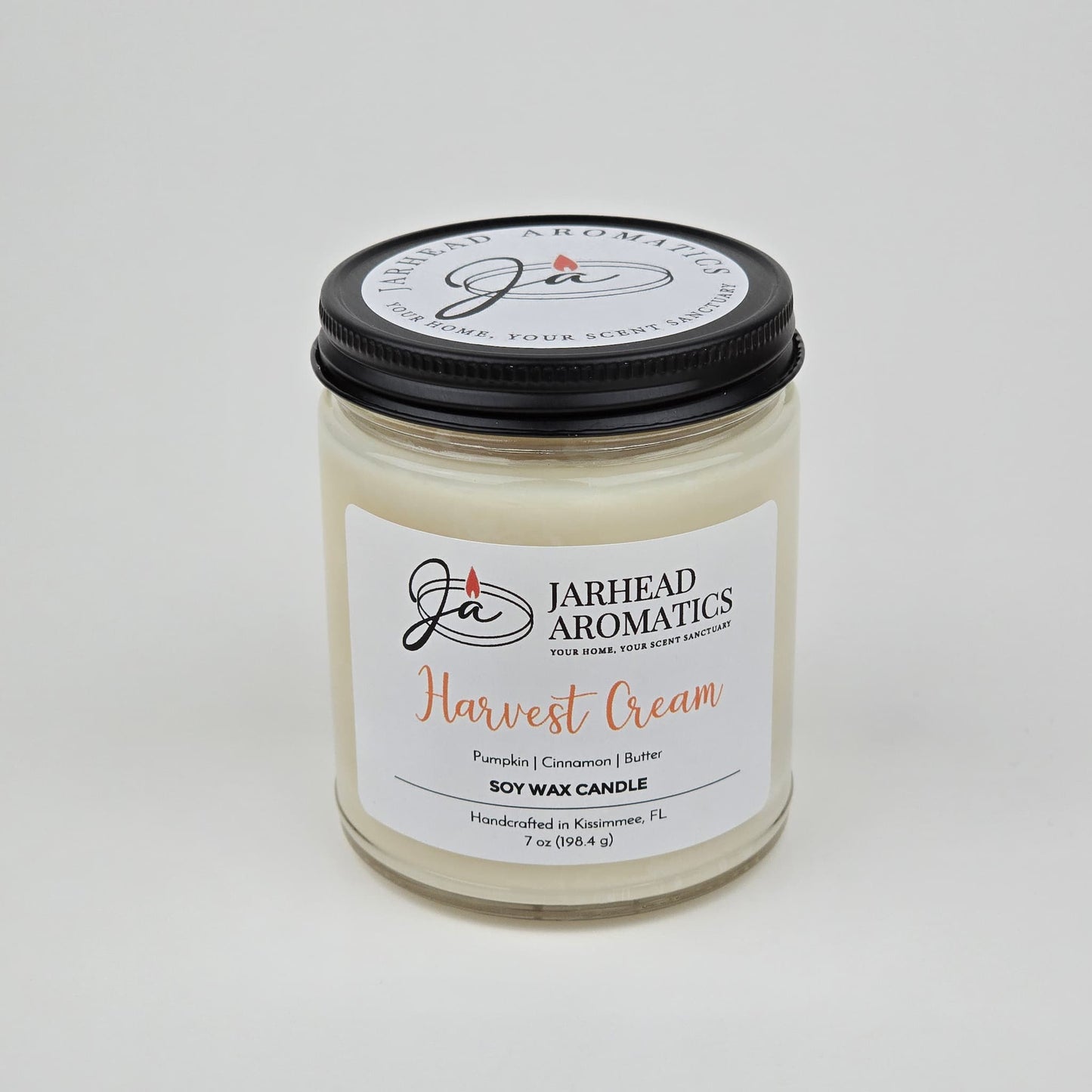 Experience the warmth of autumn with the Harvest Cream Soy Wax Candle by Jarhead Aromatics—a handcrafted 7 oz white soy wax candle in a glass jar with a black lid. Labeled “Harvest Cream,” this candle fills your space with an inviting blend of pumpkin spice, brown sugar, and vanilla. Made in Kissimmee, FL.