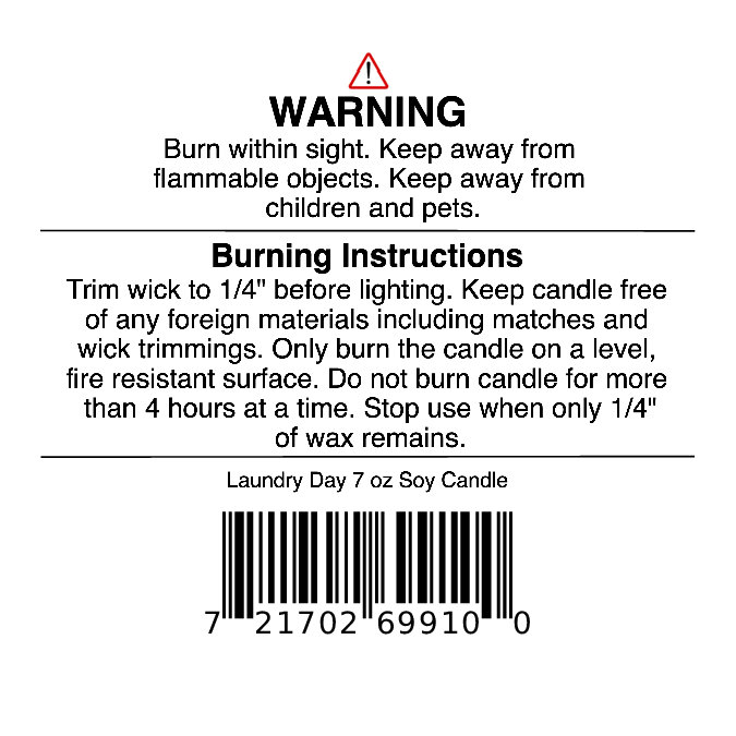 Jarhead Aromatics warning label includes safety and burning instructions, a barcode, and guidance to trim the wick, keep away from flammable objects, and avoid burning for more than 4 hours. This Fresh Linen, Lemon & Light Musk candle delivers a clean fragrance experience. The Laundry Day Soy Wax Candle | Fresh Linen, Lemon & Light Musk Candle 7 oz is noted at the bottom.