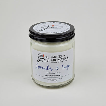 The Jarhead Aromatics Lavender & Sage Soy Wax Candle features calming lavender, sage, and sandalwood scents. Hand-poured in Kissimmee, FL, this glass jar candle with a black lid is perfect for adding relaxation to any space.