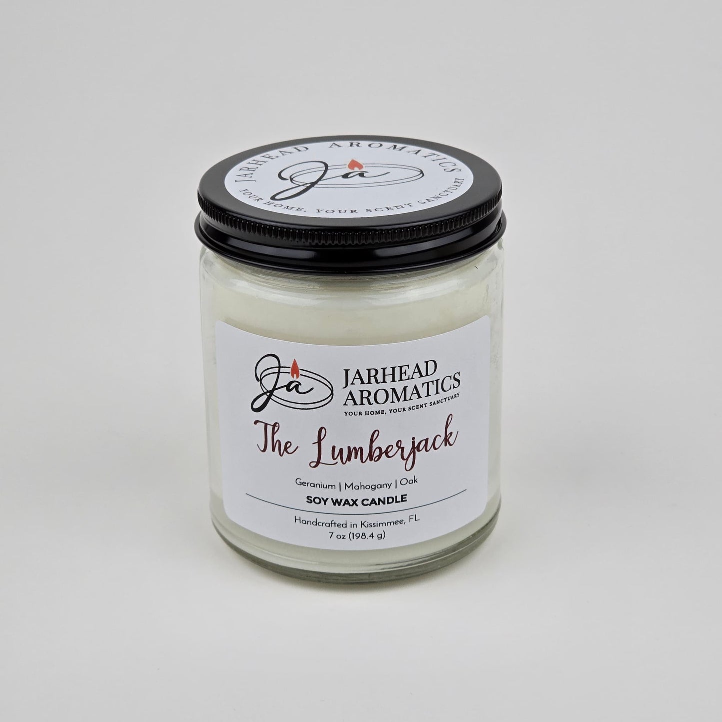 The Lumberjack Soy Wax Candle by Jarhead Aromatics features a cedar, oak, and mahogany scent. Handcrafted in Kissimmee, FL, this masculine candle comes in a glass jar with a black lid.