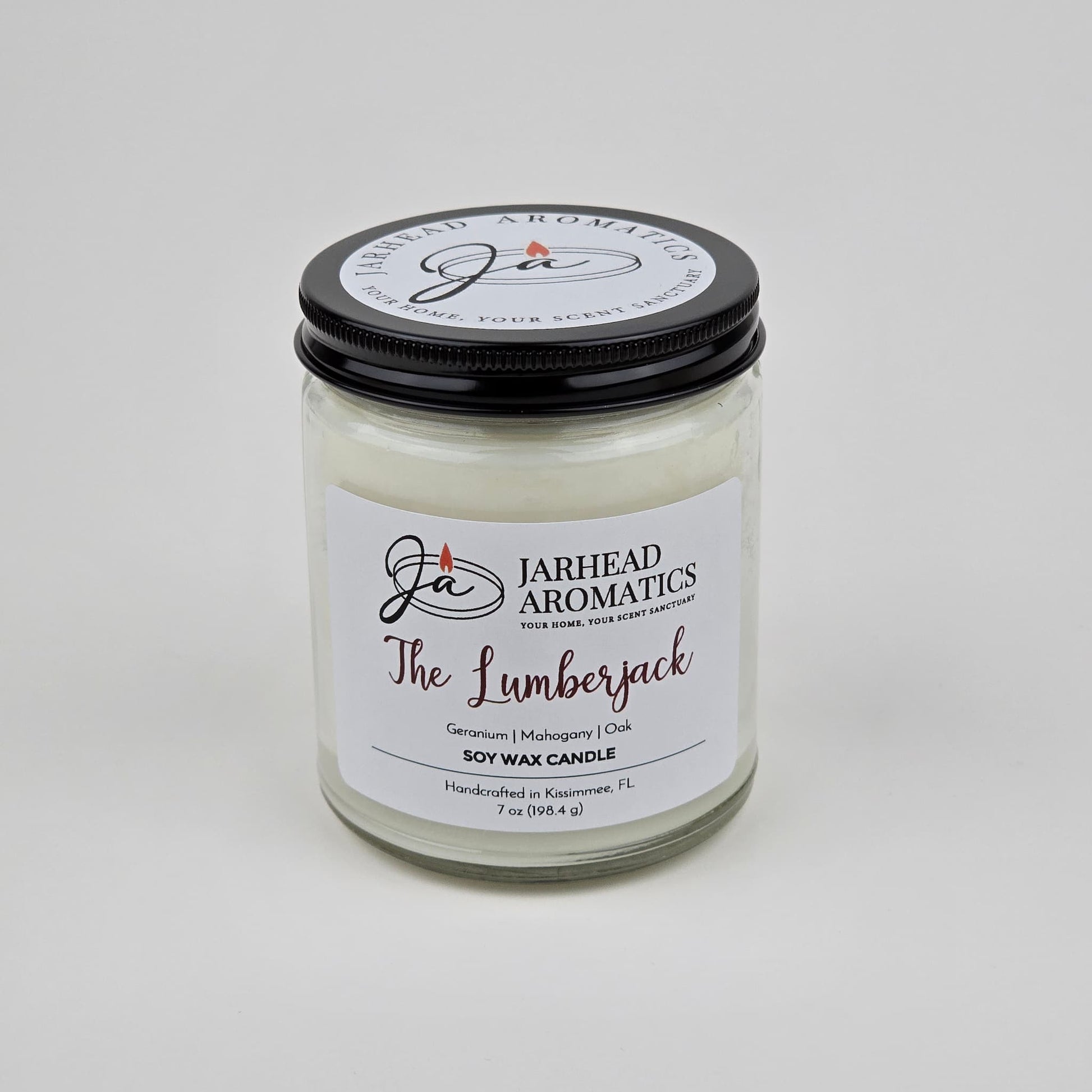The Lumberjack Soy Wax Candle by Jarhead Aromatics features a cedar, oak, and mahogany scent. Handcrafted in Kissimmee, FL, this masculine candle comes in a glass jar with a black lid.