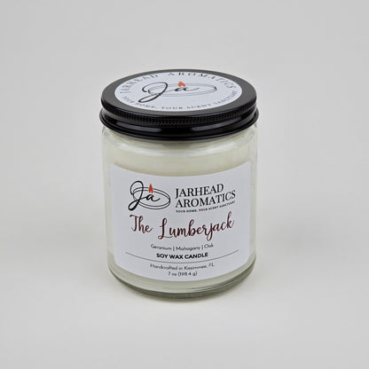The Lumberjack Soy Wax Candle by Jarhead Aromatics features a cedar, oak, and mahogany scent. Handcrafted in Kissimmee, FL, this masculine candle comes in a glass jar with a black lid.