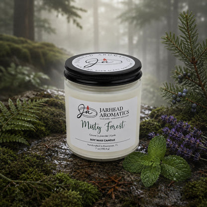 A Misty Forest Soy Wax Candle | Earthy Moss, Lavender & Juniper Candle by Jarhead Aromatics rests on a bed of moss in a misty woodland, encircled by pine branches, lavender blossoms, and mint leaves. This natural soy wax candle captures the true essence of the forest with earthy moss and fragrant undertones of lavender and juniper, infusing your space with the calming aroma of the woods.