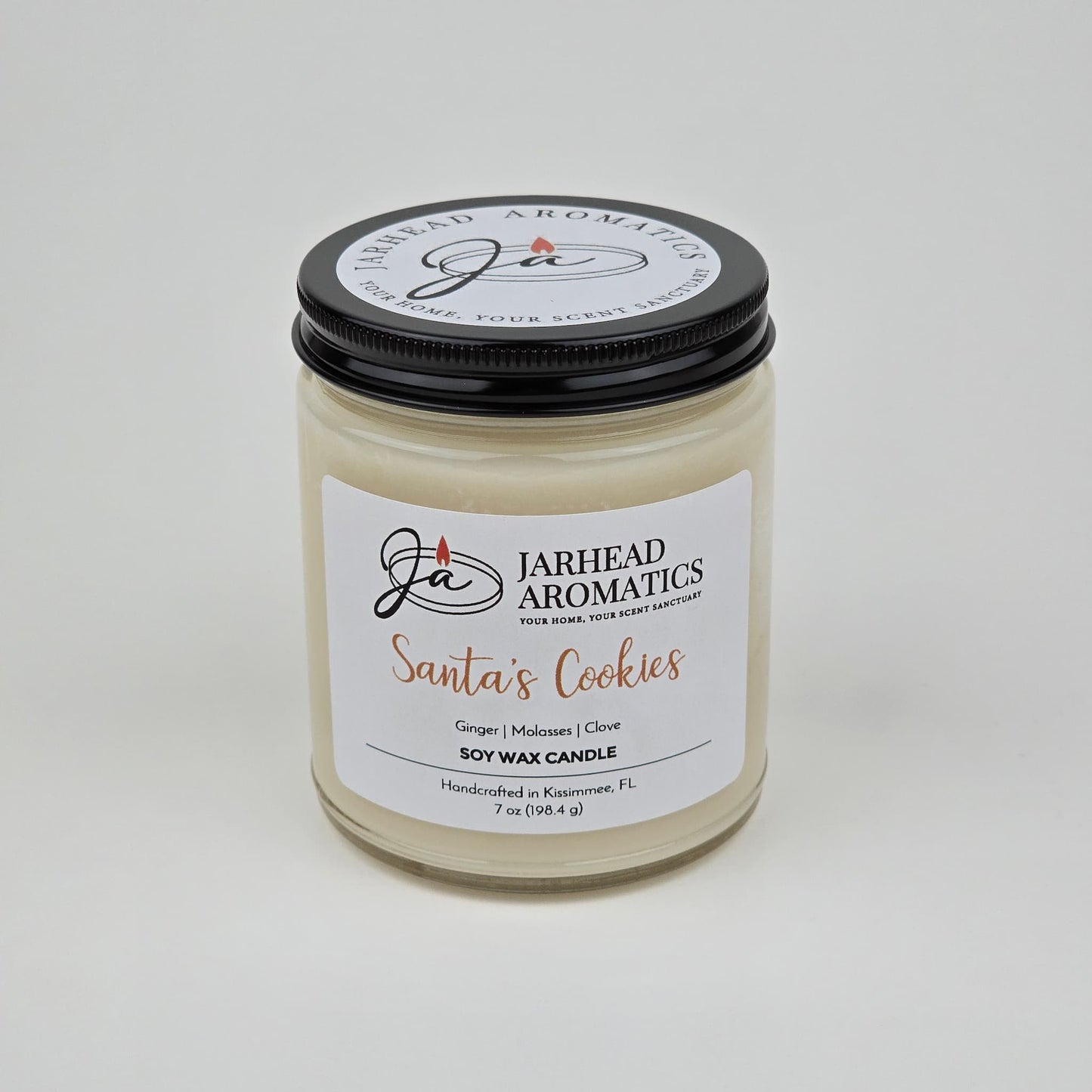 Introducing the Jarhead Aromatics Santa’s Cookies Soy Wax Candle, a 7 oz holiday candle handcrafted in Kissimmee, FL. Featuring a black lid and sleek white background, this festive candle blends notes of ginger, brown sugar, molasses, and vanilla—capturing the warm aroma of classic Christmas cookies.