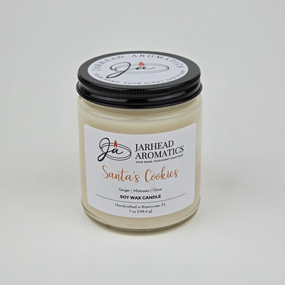 Introducing the Jarhead Aromatics Santa’s Cookies Soy Wax Candle, a 7 oz holiday candle handcrafted in Kissimmee, FL. Featuring a black lid and sleek white background, this festive candle blends notes of ginger, brown sugar, molasses, and vanilla—capturing the warm aroma of classic Christmas cookies.