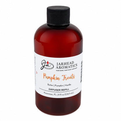 A brown bottle labeled Jarhead Aromatics Pumpkin Treats Diffuser Refill stands upright on a white background. Infused with the inviting scents of pumpkin, caramel, and maple pecan, this autumn home fragrance creates a cozy atmosphere in any room. The bottle features a black cap and an 8 fl oz (236.5 mL) label.