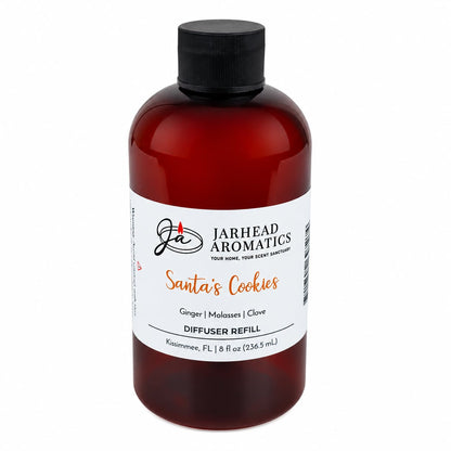 Amber plastic bottle of Santa’s Cookies Diffuser Refill with a black screw cap, featuring scent notes of ginger, brown sugar, molasses, and vanilla.
