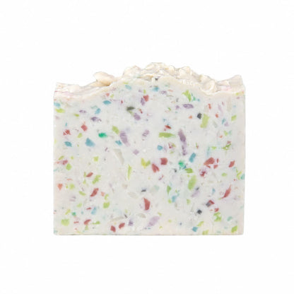 A rectangular bar of Almond + Berry Handmade Coconut Milk Artisan Soap by Jarhead Aromatics, featuring colorful specks in green, red, blue, and purple and a textured top edge, set against a plain white background.