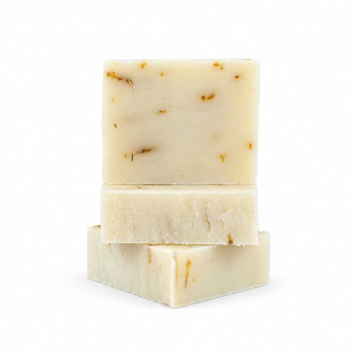 Three bars of Jarhead Aromatics Aloe + Calendula Natural Handmade Soap | Unscented Sensitive Skin Bar Soap stacked vertically, featuring off-white bars containing small pieces of dried botanicals.