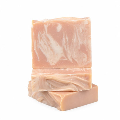 Three rectangular bars of Jarhead Aromatics’ Belgium Wheat + Citrus Handmade Craft Beer Artisan Soap are stacked against a white background. The top bar stands upright on two that are lying flat, showcasing their smooth, marbled beige and cream swirled texture.