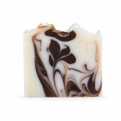 Introducing the Cedarwood + Cocoa Handmade Natural Tallow Artisan Soap by Jarhead Aromatics—a rectangular bar of soap featuring a white base adorned with intricate dark brown swirls, creating a striking marbled pattern. Its uneven top edge showcases the distinct handmade character typical of natural artisan soaps. Enjoy the warm aroma of cedarwood paired with earthy cocoa in every luxurious lather.