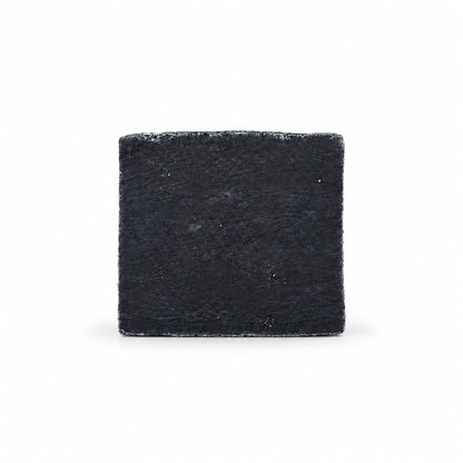 A square, black Jarhead Aromatics Charcoal Natural Handmade Soap bar with a textured surface.