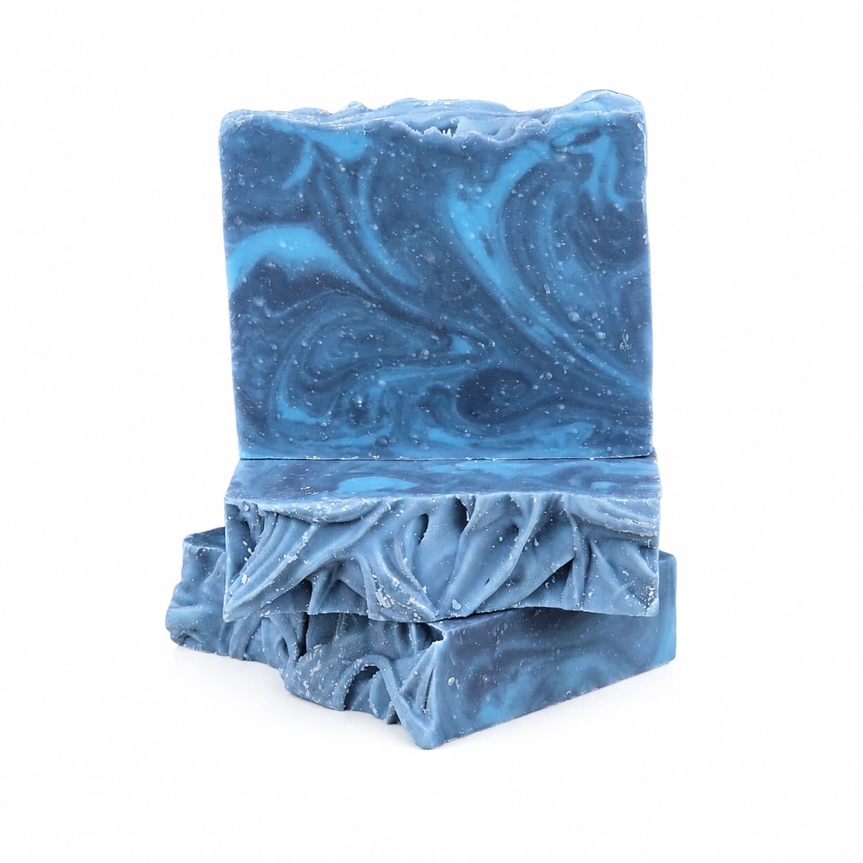 Two rectangular bars of Jarhead Aromatics’ Citron + Cedarwood Handmade Coconut Milk Artisan Soap, featuring blue marbled swirls and textured edges, stacked on a white background. These handcrafted soaps blend bright citrus and woodsy cedar fragrances with nourishing coconut milk for a luxurious bathing experience.