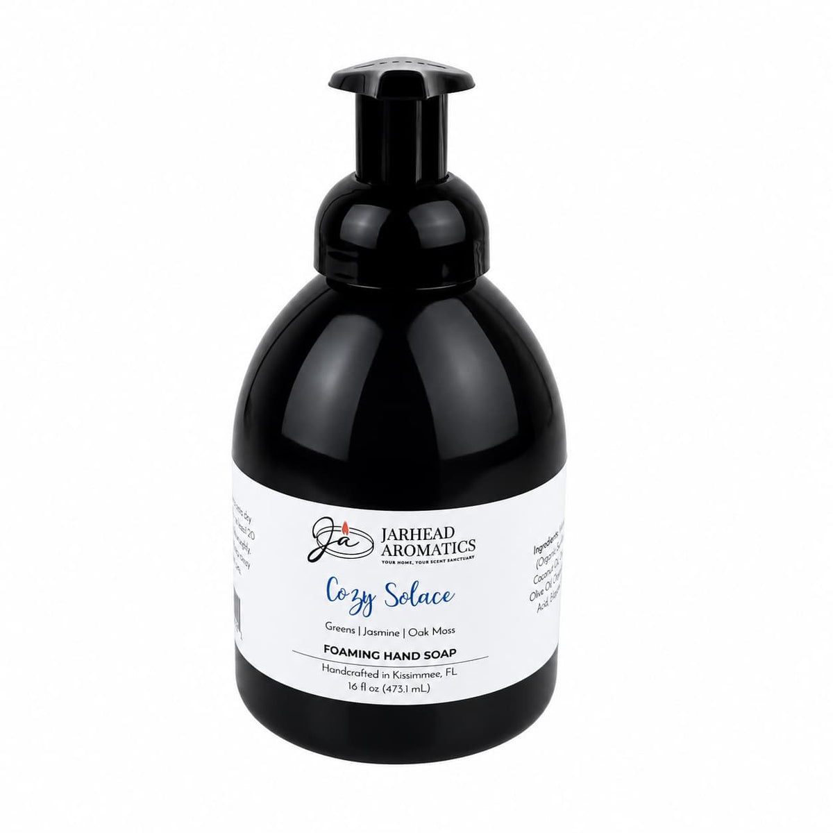 Black bottle of Jarhead Aromatics Cozy Solace Handmade Foaming Hand Soap with a pump dispenser and a white label reading Cozy Solace, Greens | Jasmine | Oak Moss.