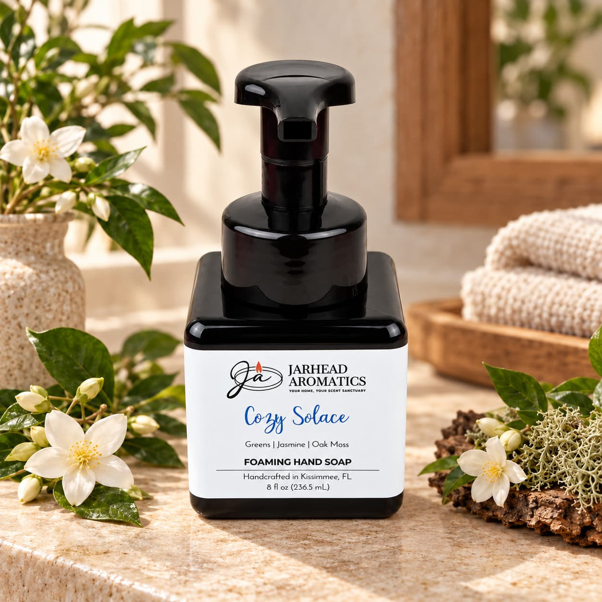 Black square bottle of Cozy Solace Handmade Foaming Hand Soap with a white label featuring the product name, botanical fragrance, and Jarhead Aromatics brand details.