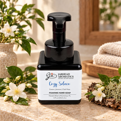 Black square bottle of Cozy Solace Handmade Foaming Hand Soap with a white label featuring the product name, botanical fragrance, and Jarhead Aromatics brand details.