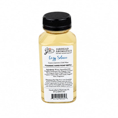 A bottle of Cozy Solace Handmade Foaming Hand Soap with a label listing ingredients, directions for use, and a barcode.