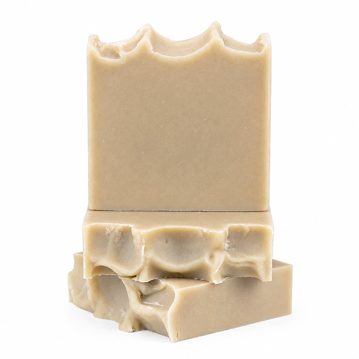 Three beige Eucalyptus + Mint Handmade Natural Goat Milk Artisan Soap bars from Jarhead Aromatics are stacked, featuring rough, textured tops, smooth sides, and an organic, natural appearance against a plain white background.