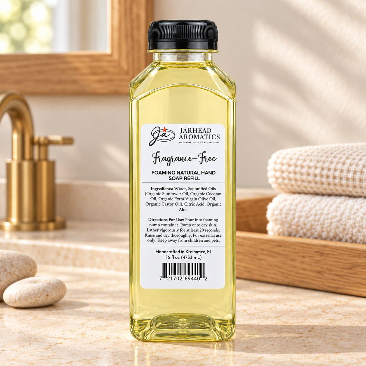 A tall, clear bottle of Jarhead Aromatics Fragrance-Free Handmade Foaming Natural Hand Soap refill with a black cap, showing a label with ingredient and usage instructions.