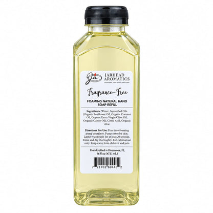 A clear plastic bottle of Jarhead Aromatics Fragrance-Free Handmade Foaming Natural Hand Soap, featuring light yellow unscented soap, a black cap, and a label with ingredients, directions, and volume.