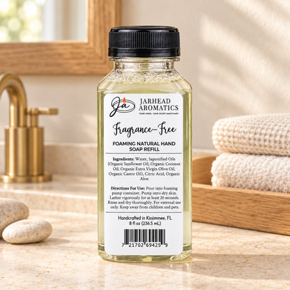 Clear glass bottle of Jarhead Aromatics Fragrance-Free Handmade Foaming Natural Hand Soap refill with a black cap and a white label featuring ingredients, directions, and a barcode.