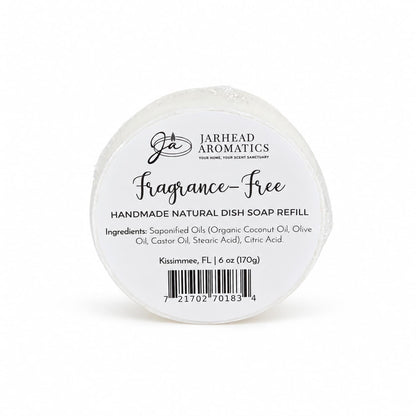 Round, handmade Jarhead Aromatics Fragrance-Free Handmade Natural Solid Dish Soap | Kitchen Cleaning Bar with a label listing ingredients and confirming it is fragrance-free.